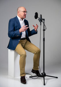 Full length shot of James Fowler voiceover making angry noises into the mic.