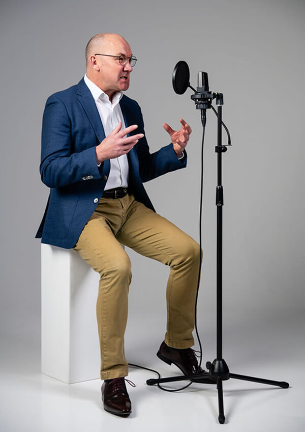 Full length shot of James Fowler voiceover making angry noises into the mic.