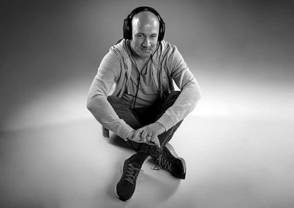 James Fowler voiceover sat on the floor smiling at the camera.