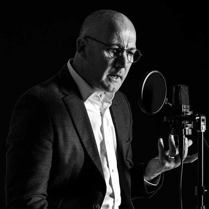 Black and white square photo of James Fowler voiceover.